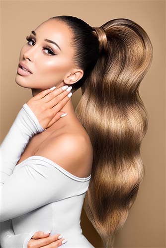 Woman with long, full Chocolate Dark Brown & Light Brown Caramel hair from invisible tape-ins – Rubin Extensions®